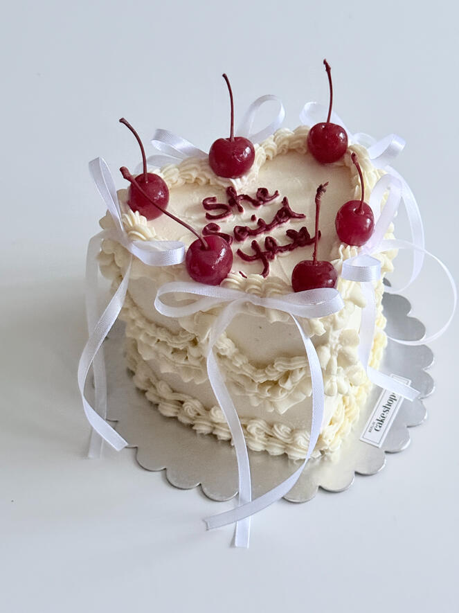 Heart shaped engagement vintage cake with bows and cherries