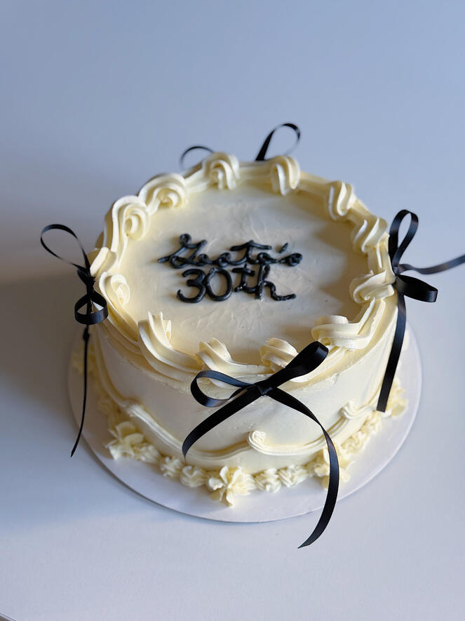 simple elegant white vintage cake with black bows